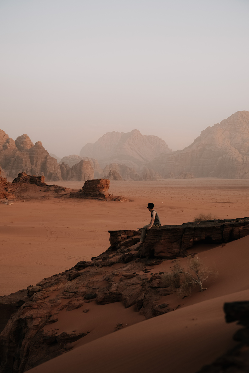 Man Sitting on a Rock in the Wadi Rum Valley in Jordan